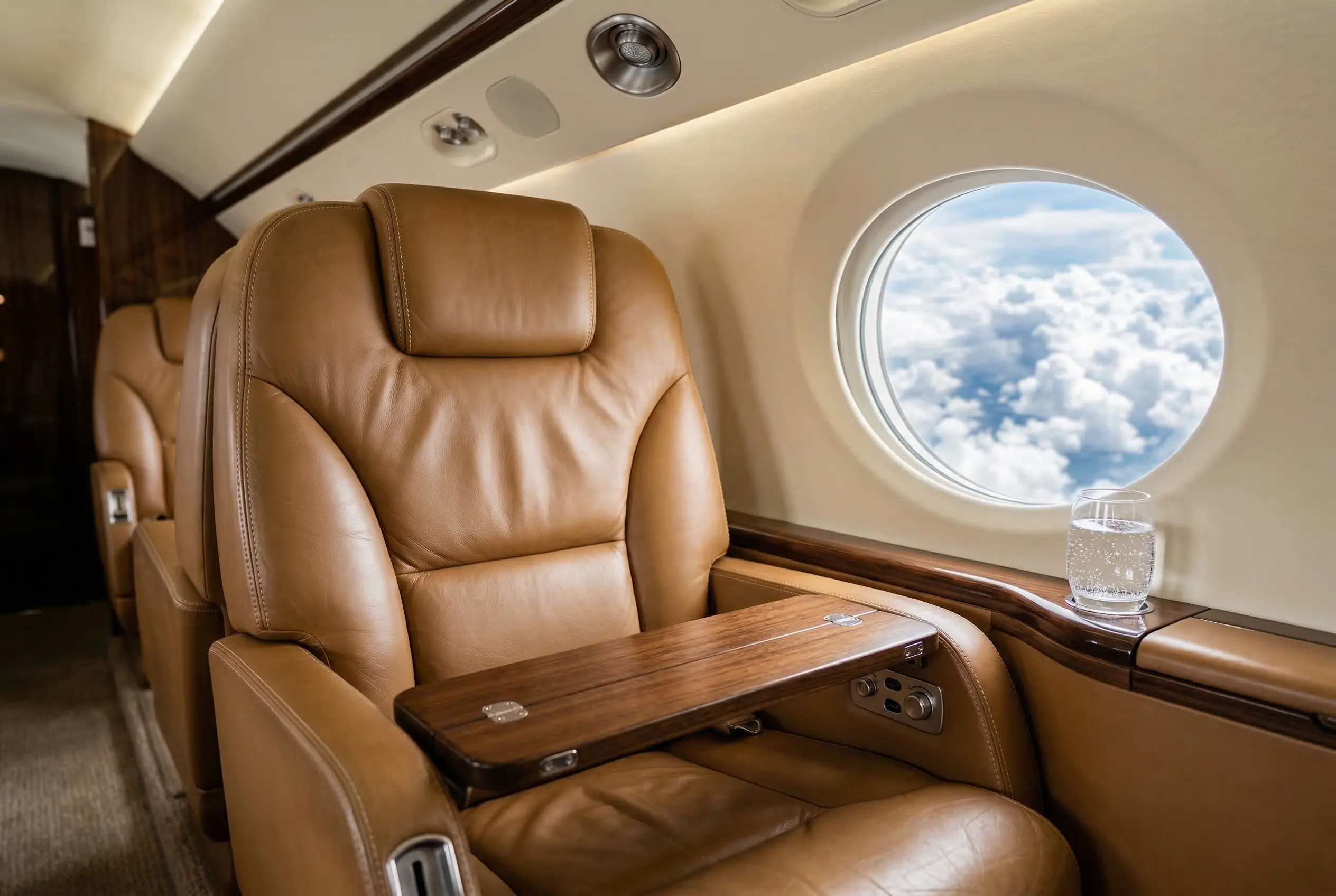 Premium leather seating and amenities inside a private jet cabin